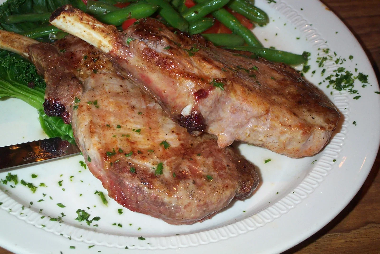 Pan-seared pork chops with a browned crust, butter, garlic and thyme