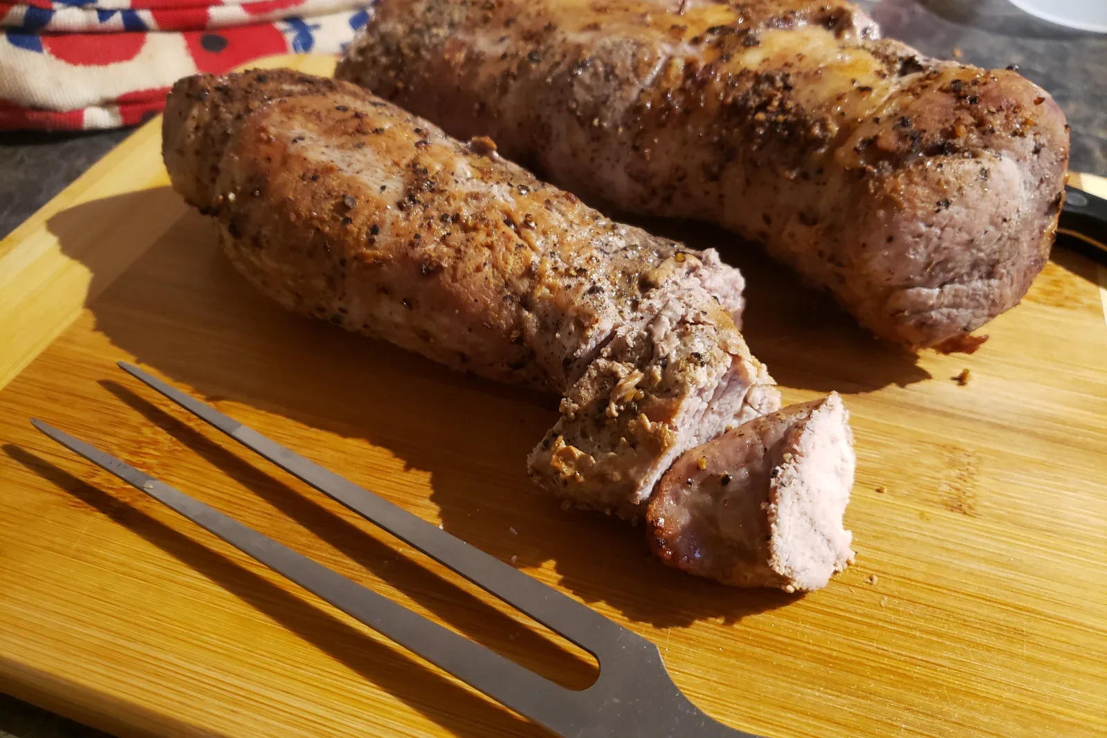 Roasted pork tenderloin sliced into juicy medallions with browned edges and herbs